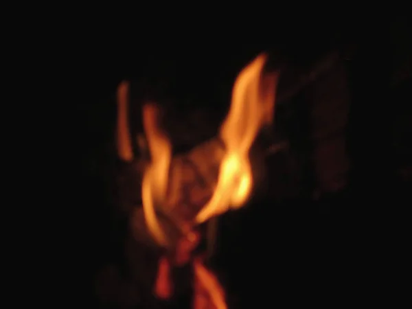 黒い背景に燃える暖炉のぼやけた炎 — ストック写真