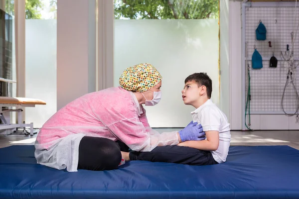 Female Physical Therapist Disabled Child Blue Mattress Doing Rehabilitation Exercise — Stock Photo, Image