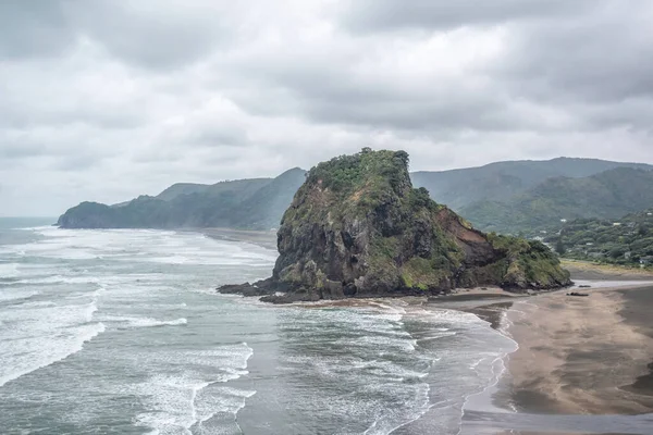 View of Piha Lion Rock on cloudy day