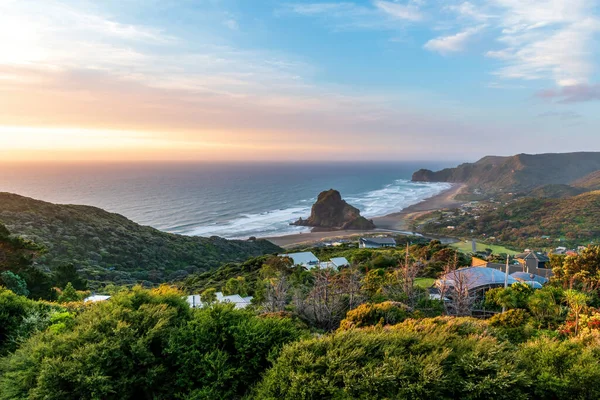 Lion Rock ve Piha köyü ile Piha sahilinin geniş açılı görüntüsü.