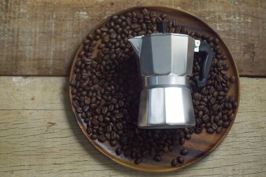 Kavrulmuş kahve çekirdekleri ve grunge ahşap üzerinde Moka kabı arka plan olarak kullanılabilir.
