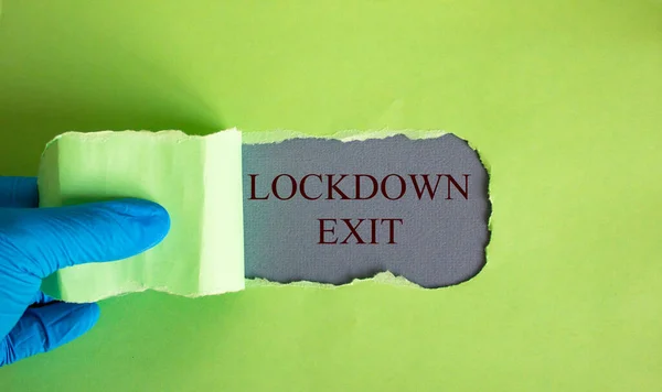 Texten Lockdown Utgång Visas Bakom Rivna Gult Papper Hand Blå — Stockfoto
