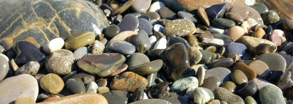 Pattern with turquoise sea stones beach on for design. Beautiful gravel background. Stone texture. Image For desktop, wallpapers, banner.