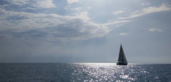 Racing yacht in the Black sea on blue sky background