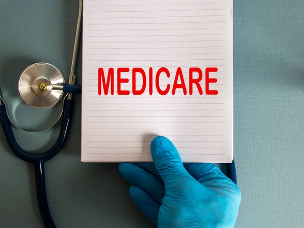 Hand Blue Glove White Card Word Medicare Stethoscope — Stock Photo, Image