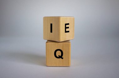 Wooden cubes with the expression 'IQ' 'Intelligence Quotient' to 'EQ' 'Emotional Intelligence Quotient'. Beautiful white background. Concept. clipart
