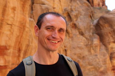 Ürdün 'de, Petra' da bir yolculuk sırasında siyah giyen gülümseyen Avrupalı turist. Güzel arkaplan.