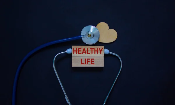 Wooden Blocks Words Healthy Life Stethoscope Black Background Wooden Heart — Stock Photo, Image