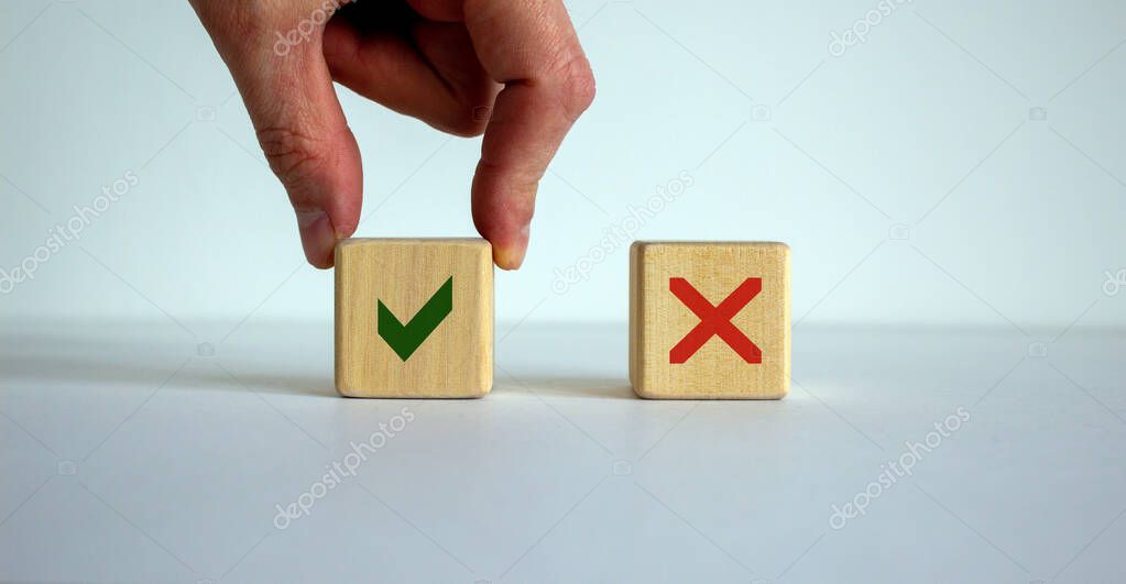 Hand making a choice between two cubes with Yes and No signs on beautiful white background. Business concept, copy space.