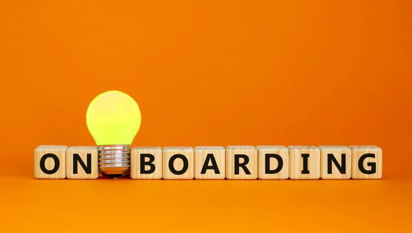 Wooden Cubes Word Onboarding Yellow Light Bulb Beautiful Orange Background — Stock Photo, Image