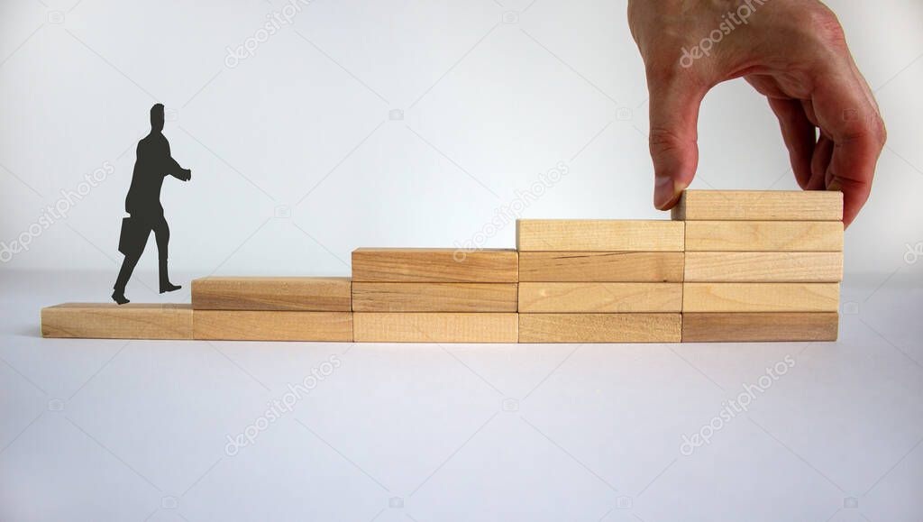 Business concept growth success process. Businessman. Male hand. Wood blocks stacking as step stair on white background, copy space. Concept of idea and innovation.