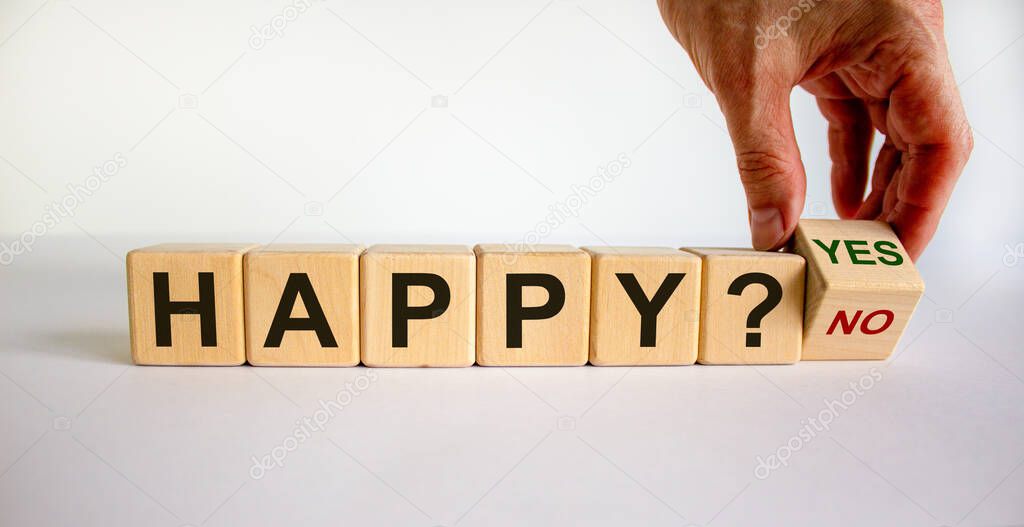 Hand flips a cube and changes the words 'happy yes' to 'happy no'. Beautiful white background. Business concept. Copy space.
