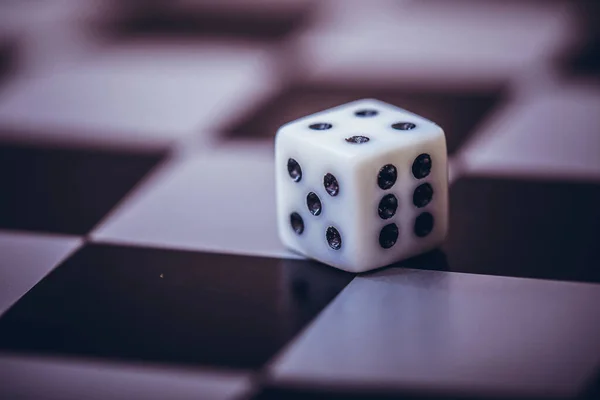 Dice on table, vintage effect. Background for casino games, gambling, luck or randomness. Rolling the dice concept for business risk, chance, good luck or gambling.