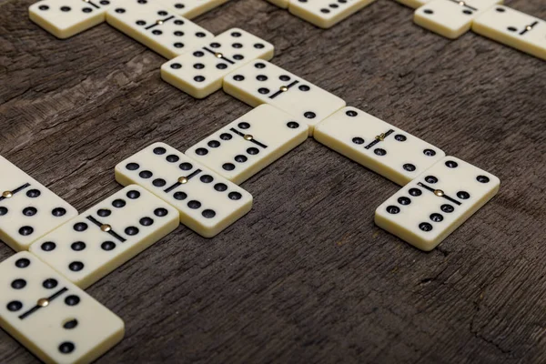 Dominoes game on old rustic wooden background. The concept of the game dominoes. High resulotion image.