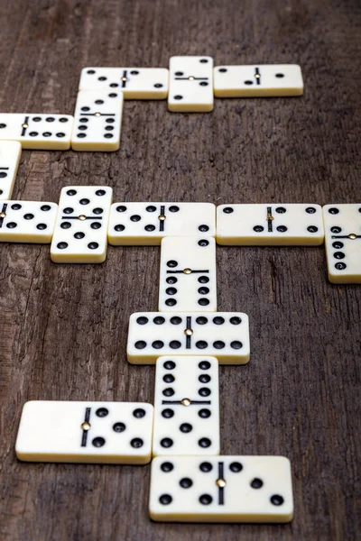 Dominoes game on old rustic wooden background. The concept of the game dominoes. High resulotion image.