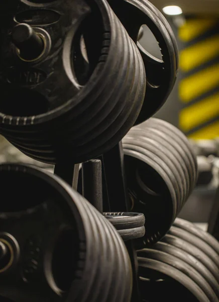 Weights in a workout gym. Gym interior close up, machinery and weightlifting equipment in modern urban style.
