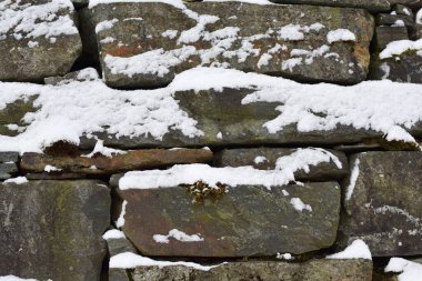 Karla kaplı taş duvar. Doku, arkaplan.