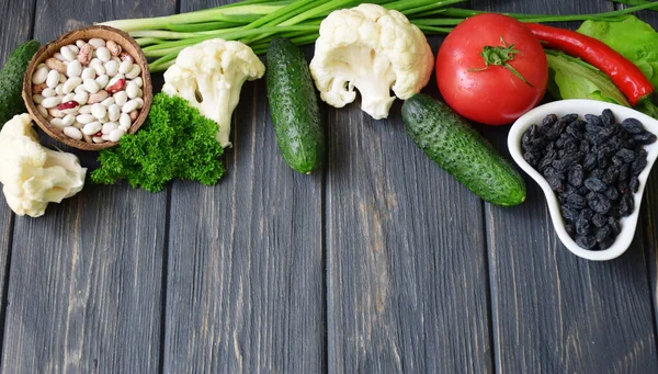 Diet plan with vegetables on a wooden dark background