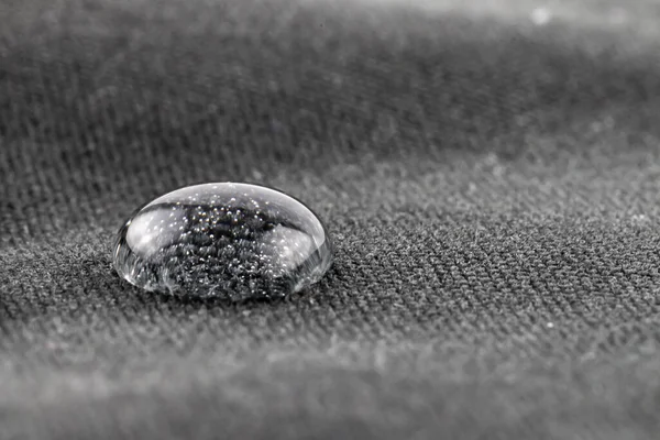 Single water bead on water repellent fabric closeup