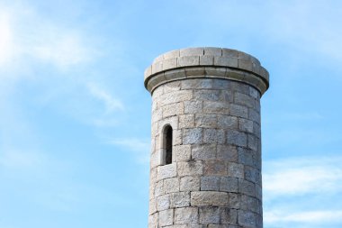 Pencereleri açık olan eski bir kale kulesinin tepesinde.