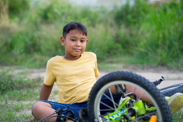 Asian kid boy have accident when ride bicycle Stock Photo