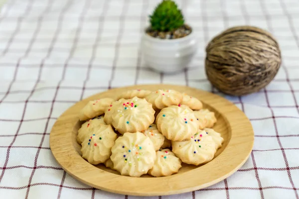 Pile of cookies on wooden plate — Stock Photo, Image