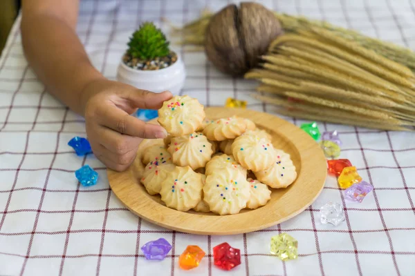 Pile of cookies on wooden plate — Stock Photo, Image