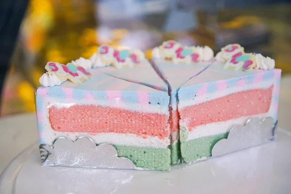 Rainbow cake on white plate — Stock Photo, Image