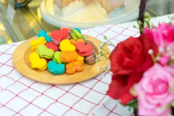 Стопка макаронного десерта в форме сердца на деревянной тарелке — стоковое фото