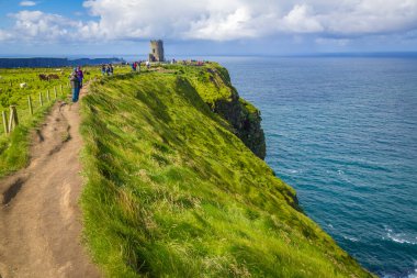 walking to O Brians Tower at the very spectacular Cliffs of Moher, Co Clare, Ireland clipart
