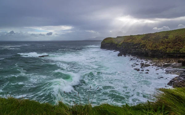 Ocean waves breaking on stone coast in Mullaghmore peninsula in County Sligo, Ireland