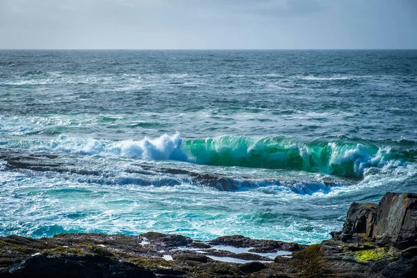 Ocean waves breaking on stone coast in Ireland