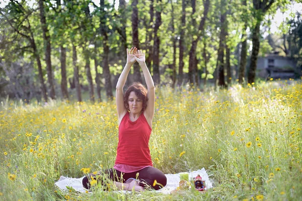 Woman practicing yoga in nature after Covid 19.