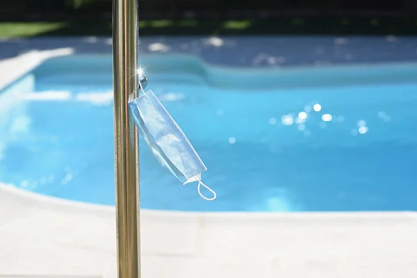 Máscara Cirúrgica Pendurada Uma Torneira Chuveiro Uma Piscina Conceito Padrões — Fotografia de Stock