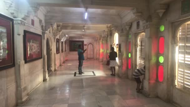 Udaipur, Indie - 13. listopadu 2019: Turisté z Městského paláce pořizují fotografie zdí v pokojích — Stock video
