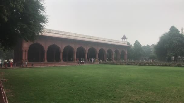 New Delhi, India, November 11, 2019, tourists walk on the other side of the green field — Stock Video