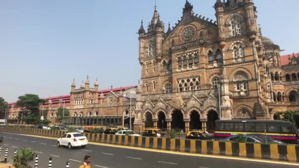 Mumbai, India - November 10, 2019: Chhatrapati Shivaji Terminus tourists walk past the building of the railway station part 3 — Stock Video