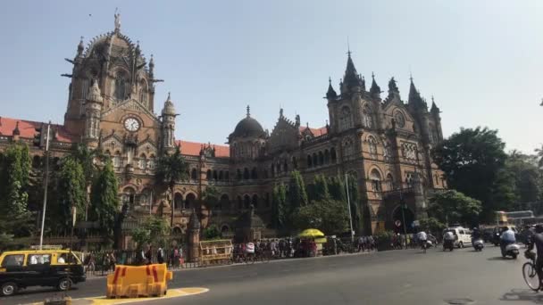 Mumbai, India - November 10, 2019: Chhatrapati Shivaji Terminus tourists walk past the building of the railway station part 8 — Stock Video