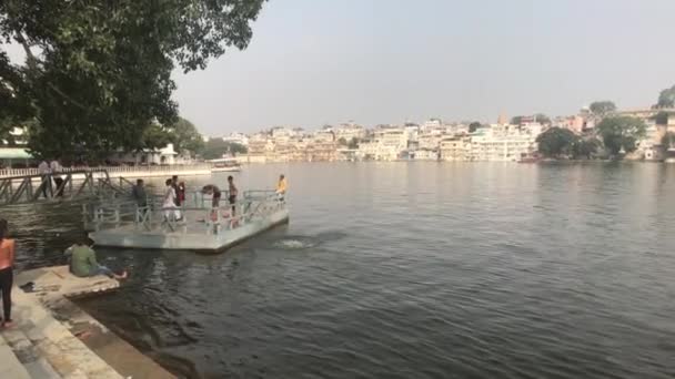 Udaipur, indien - 12. November 2019: Touristen baden im See — Stockvideo