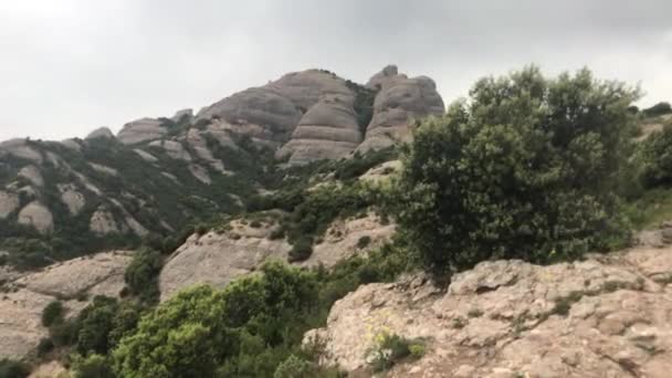 Montserrat, España, Una montaña rocosa con árboles al fondo — Vídeo de stock