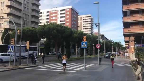 Tarragona, Spain, June 30, 2019: A group of people crossing a city street — 비디오