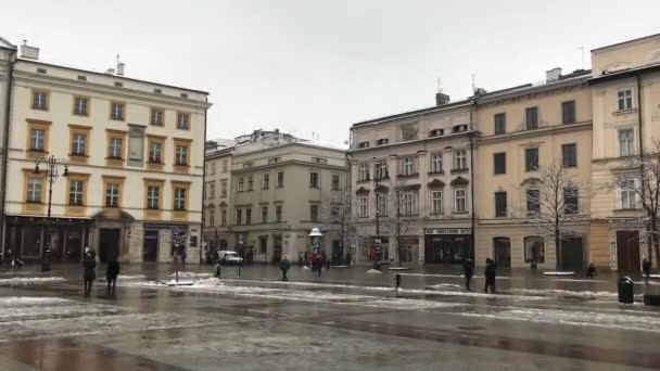 Krakow, Poland, A group of people walking in front of a building — Stock Video