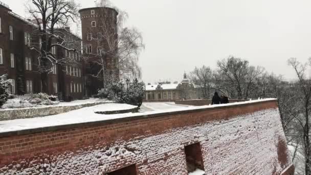 Cracovia, Polonia, Un edificio de piedra que tiene un puente al lado de una pared de ladrillo — Vídeos de Stock