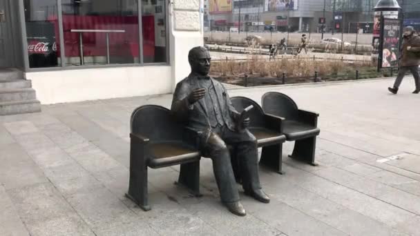 Lodz, Poland, A person sitting on a bench — Stock Video