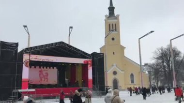 Tallinn, Estonya, bir grup insan bir binanın önünde yürüyor.