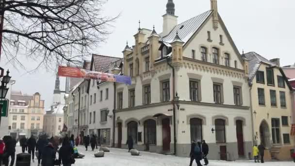 Tallinn, Estonya, bir grup insan bir binanın önünde yürüyor. — Stok video