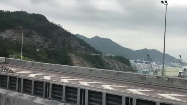 Hong Kong, China, A large building with a mountain in the background — Stock Video