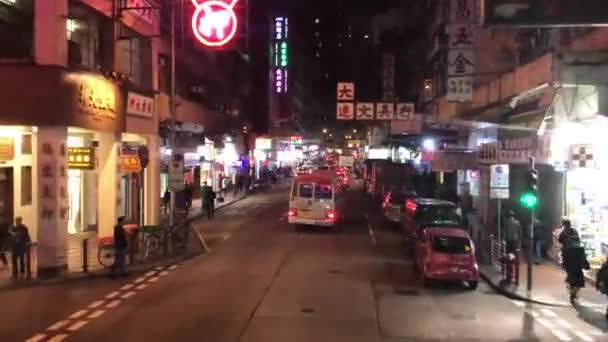 Hong Kong, China, A group of people walking on a city street at night — Stock Video