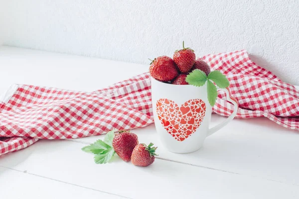 Strawberries in a cup. White table. Red cloth. Healthy breakfast. Healthy eating. Berries.