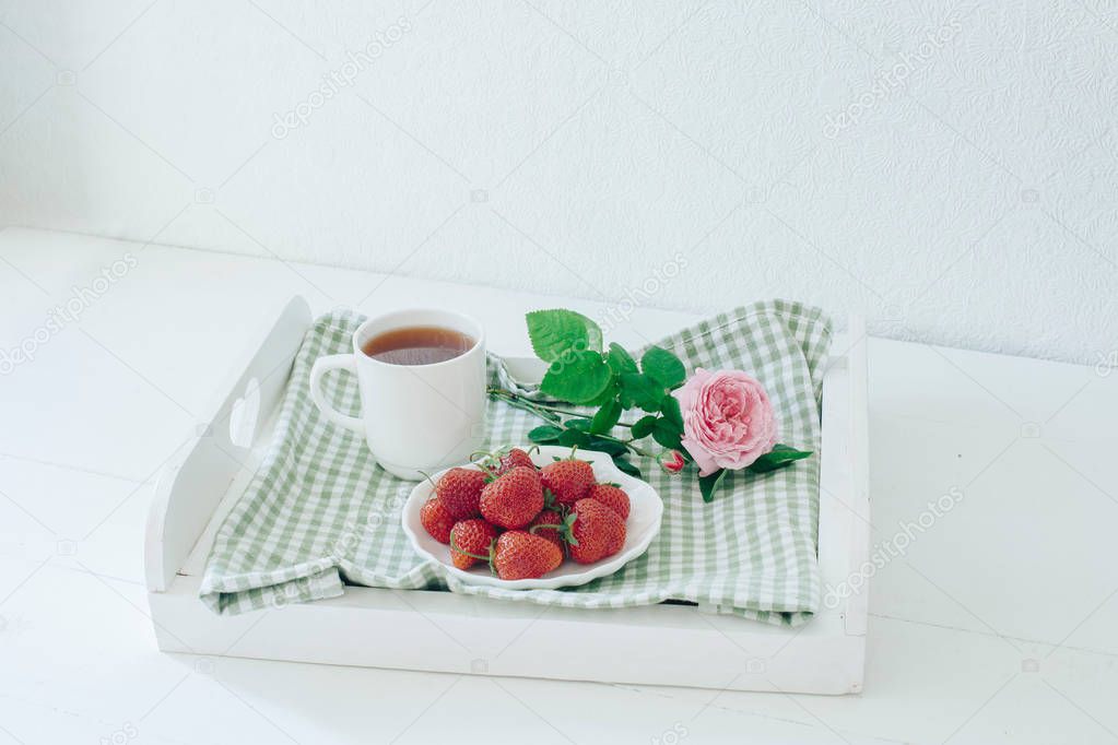 Breakfast on a tray with strawberries. Good morning. Rose